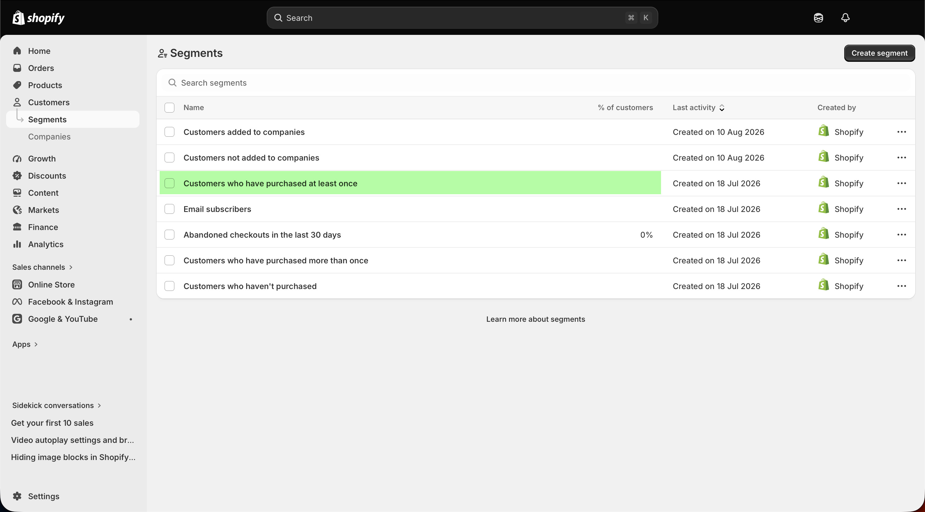 Shopify admin Segments list with 'Customers who have purchased at least once' highlighted among the default segments.